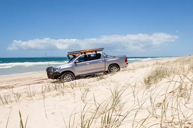 4WD driving on sand dune by the beach