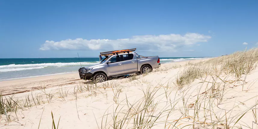 4WD driving on sand dune by the beach